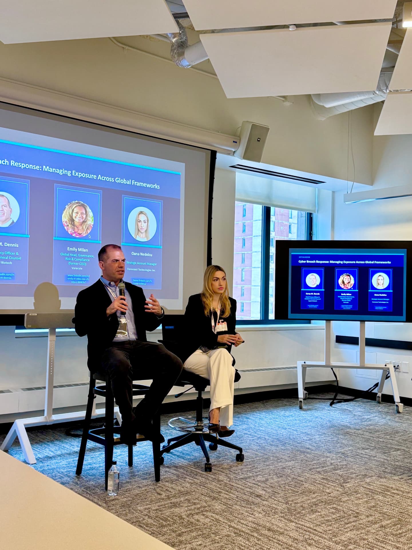 Oana Nedelcu on the CyberRisk Frontier panel in New York with the Managing Exposure Across Global Frameworks speaker slide behind